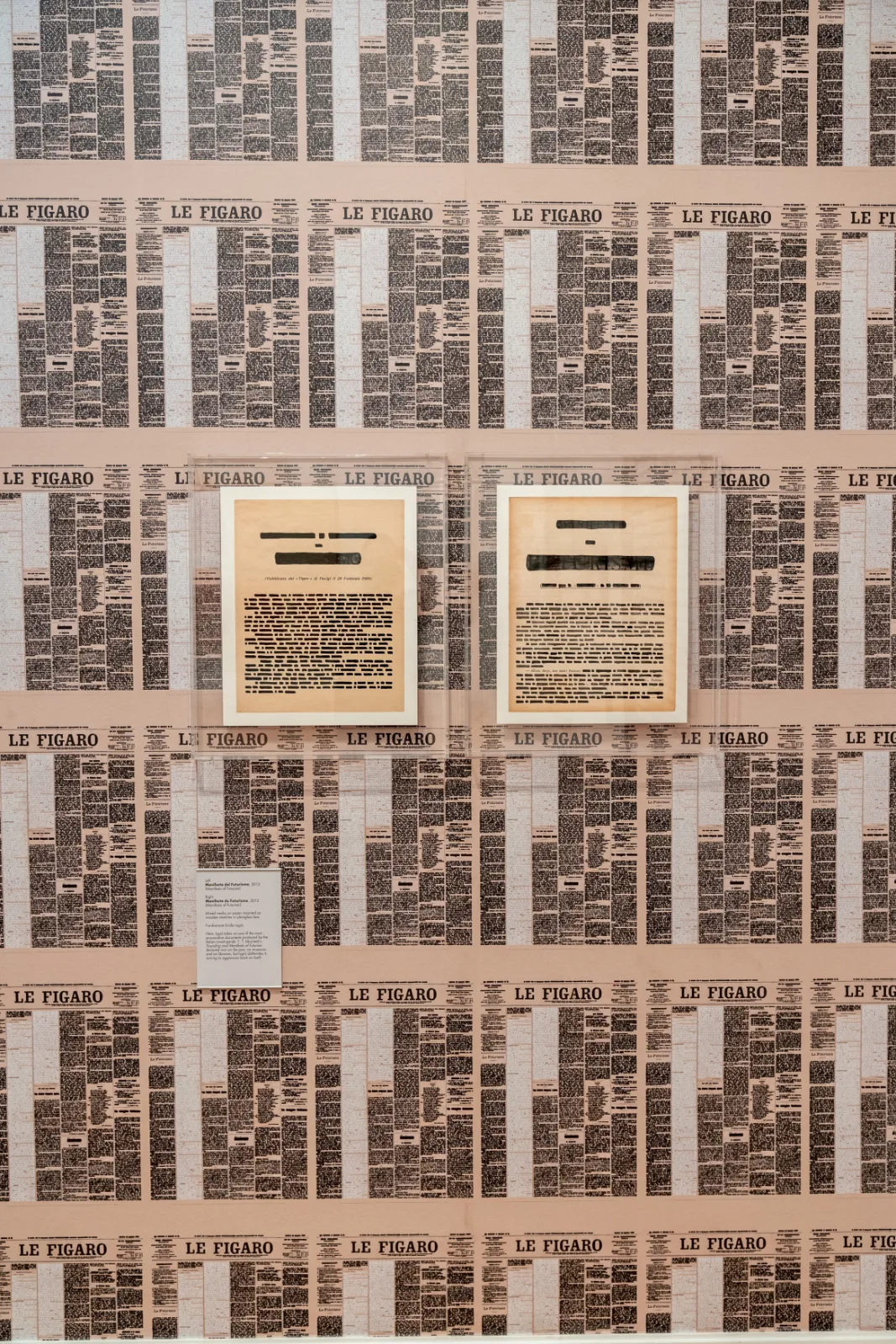 The French text of the Futurist manifesto covered in black strokes, the words Manifeste and Futurisme blacked out in heavy bars, with the publication date 20 Fevrier 1909 still legible