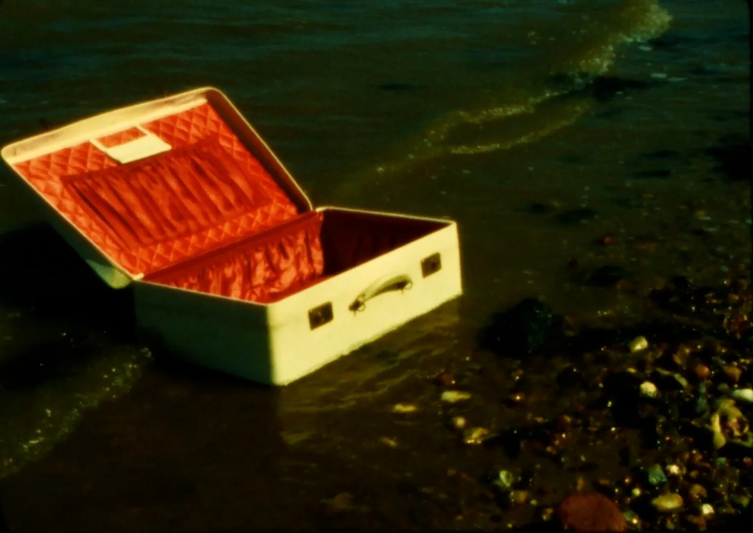 An open wooden chest floating on the waves.