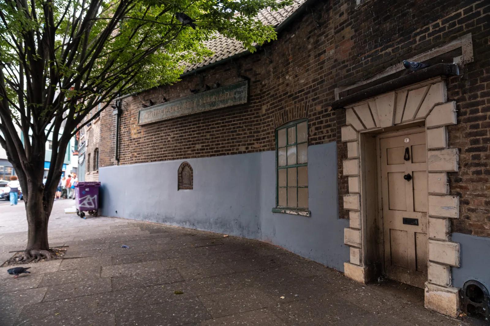 A quiet alley off the Whitechapel Road, a tree against a white wall